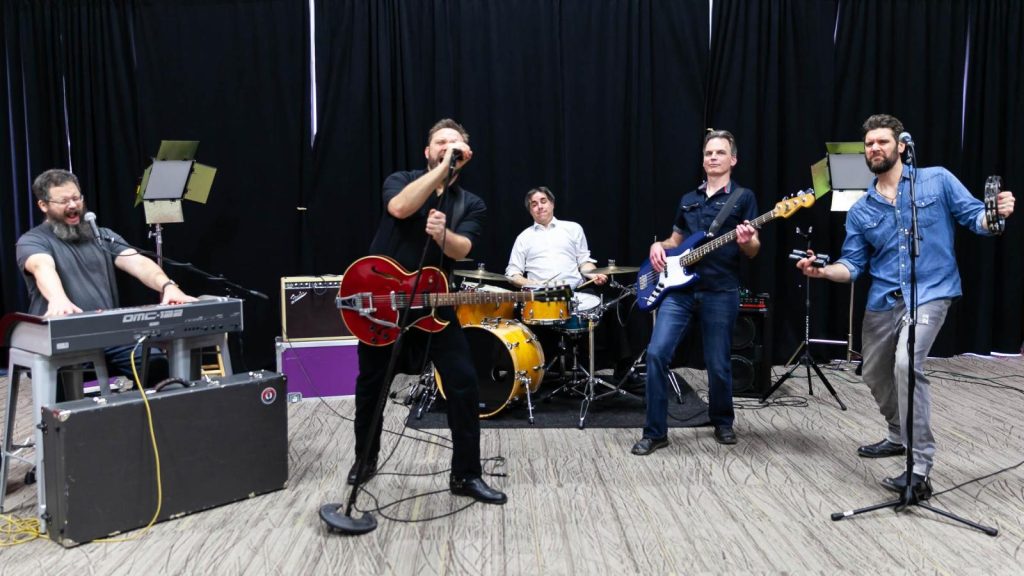j.bell band on stage with instruments